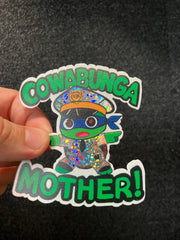 Sticker with colorful design and text held against a dark background