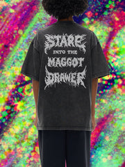 Person wearing a black t-shirt with text on the back against a colorful, abstract background
