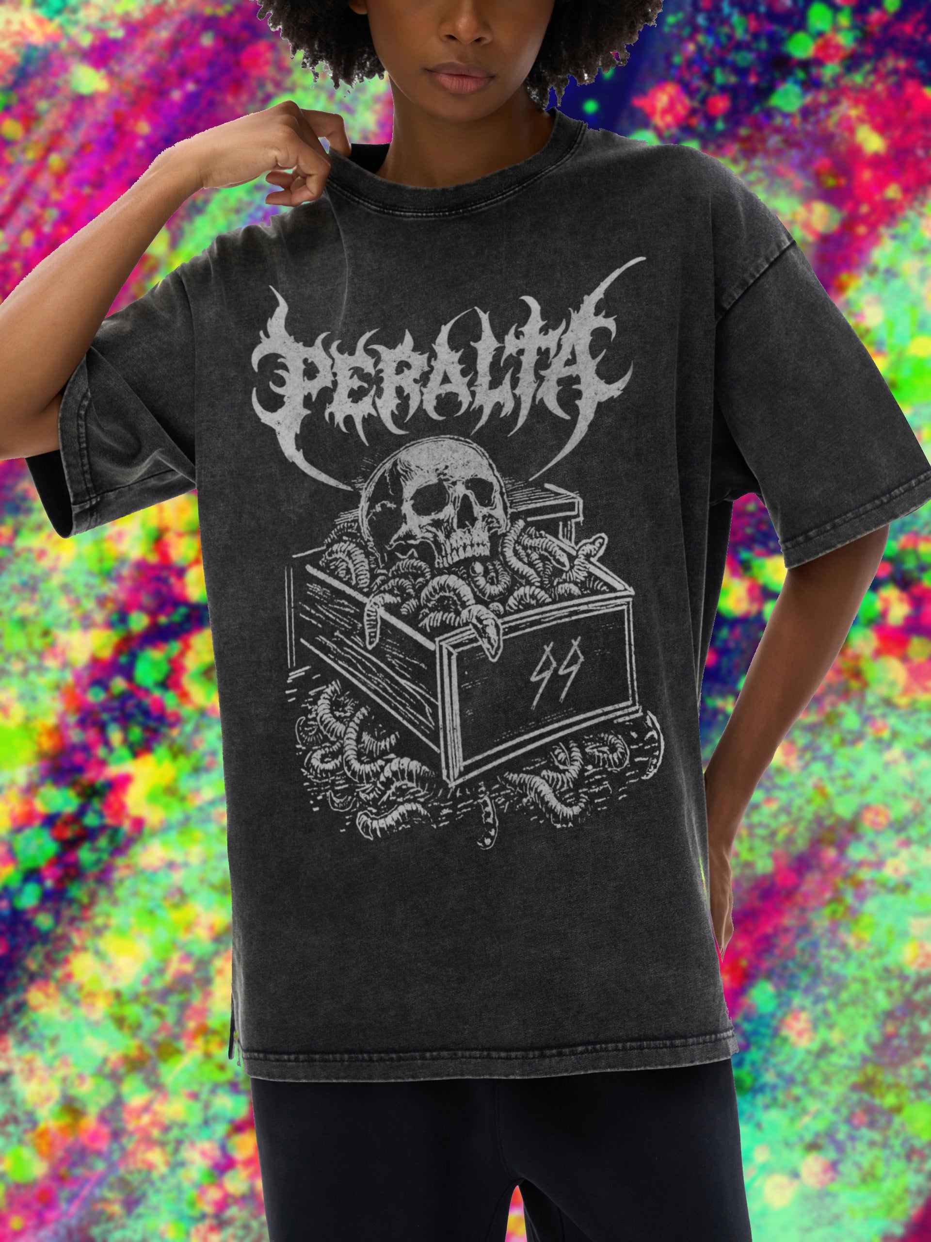 Person wearing a black t-shirt with a graphic design and text, standing against a colorful, abstract background.
