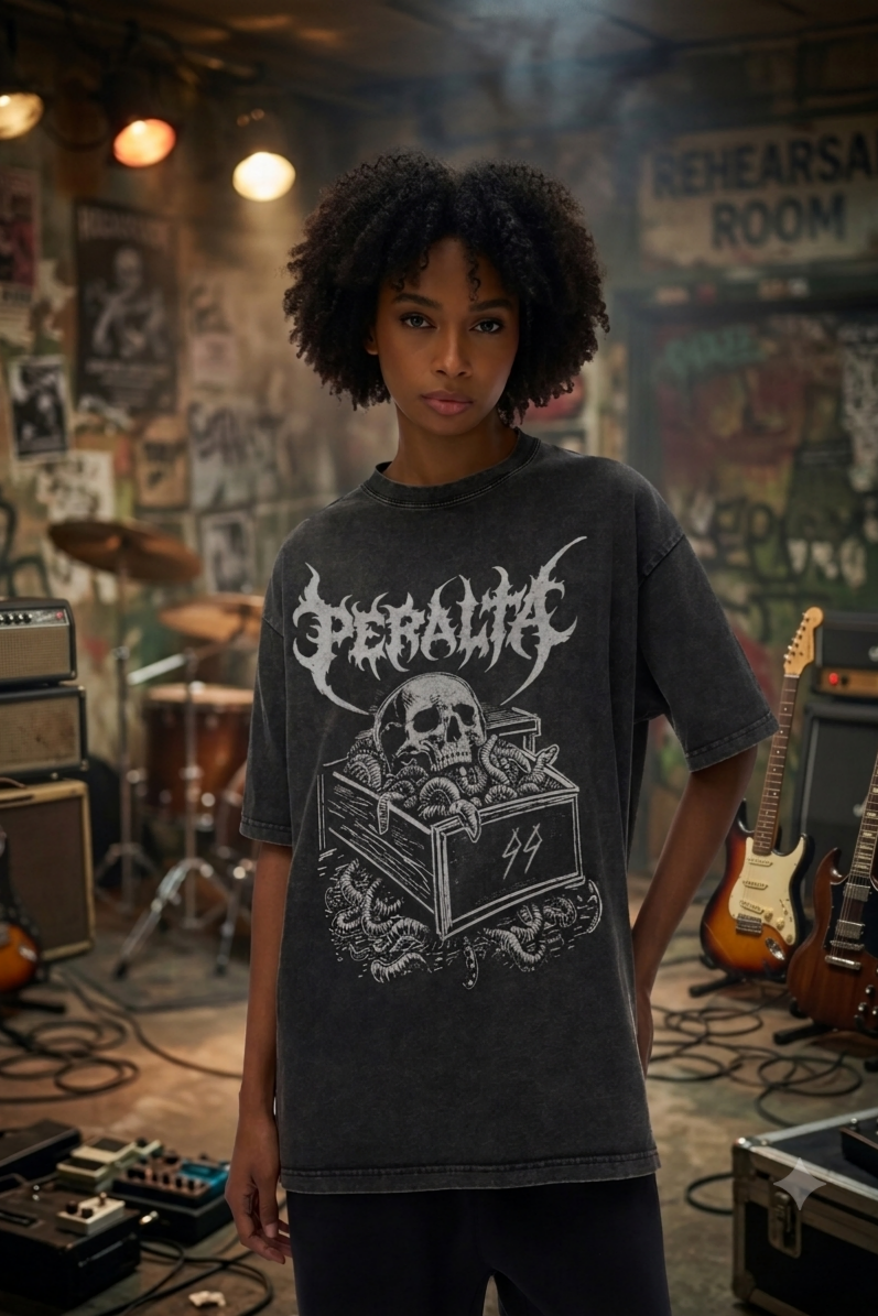 Person wearing a black t-shirt with a graphic design in a rehearsal room setting