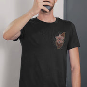 Video of a Black t-shirt worn by a man , featuring a detailed red and gold abstract design with a lightning bolt pattern on the chest with a Stranger Things inspired character popping out, on the back a gold and red design with another Stranger Things inspired character  and distressed text that reads "We've Been Building It For You" 
